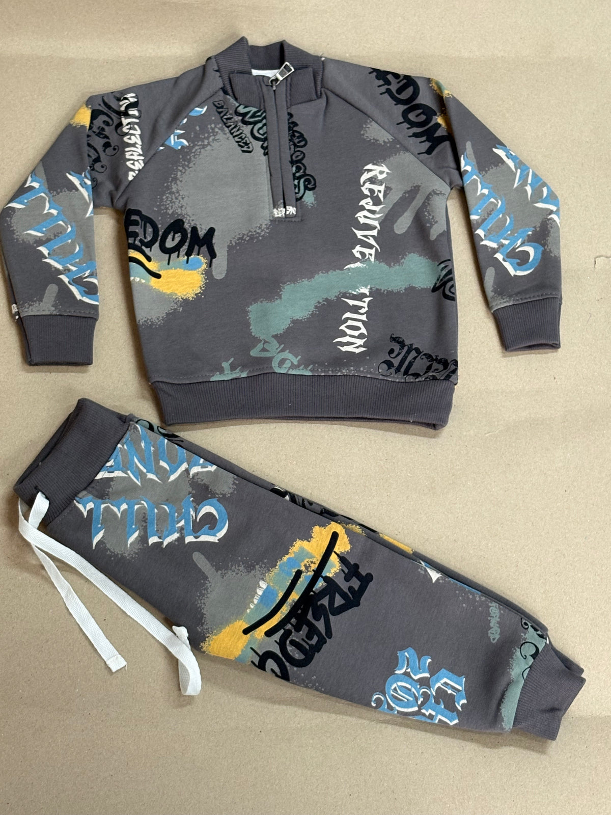 Grey kids' tracksuit featuring an all-over multi-colored graffiti and text print- Baby winter set